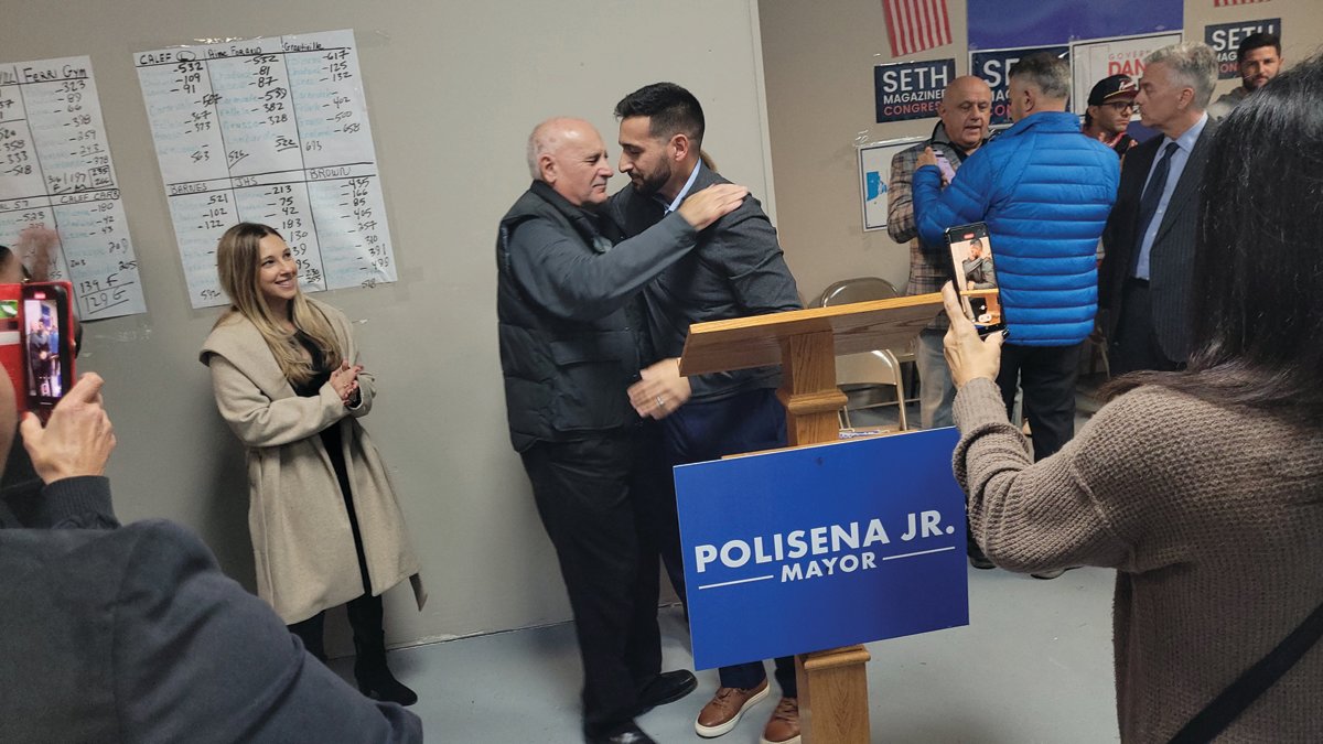 MAYOR ELECT: Mayor-elect Joe Polisena Jr. hugs his father, current Johnston Mayor Joseph Polisena, after Tuesday night’s victory was clear.